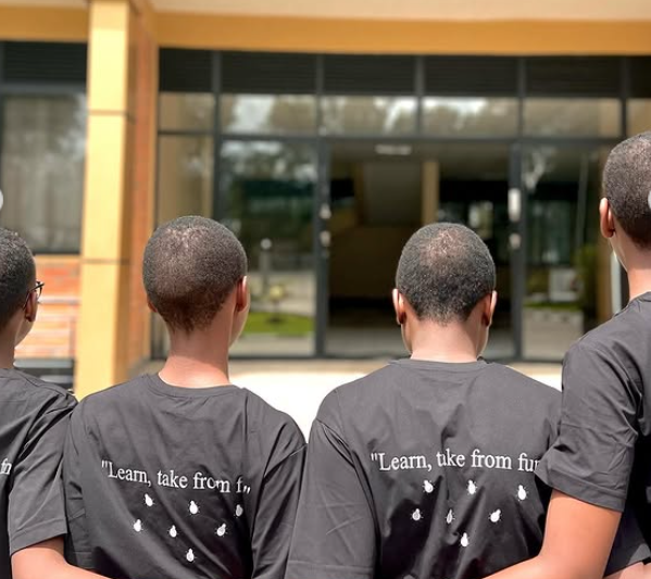 Women facing backward with meaningful words in their back shirt
